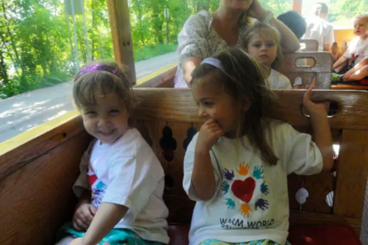 a little girl sitting on a table