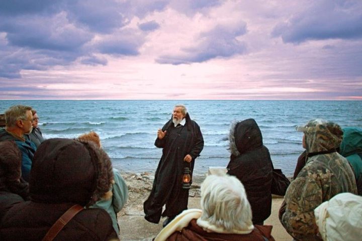 a group of people on a beach near a body of water