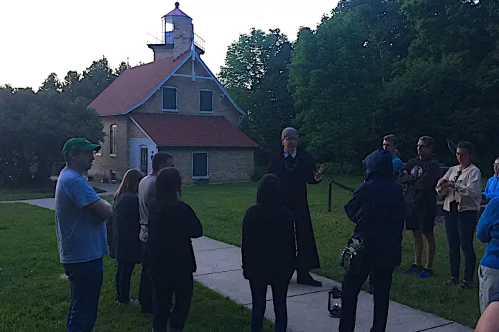 a group of people that are standing in the grass