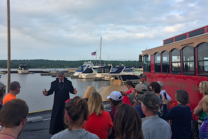 a group of people standing next to a train