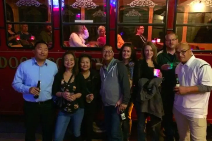 a group of people standing in front of a bus