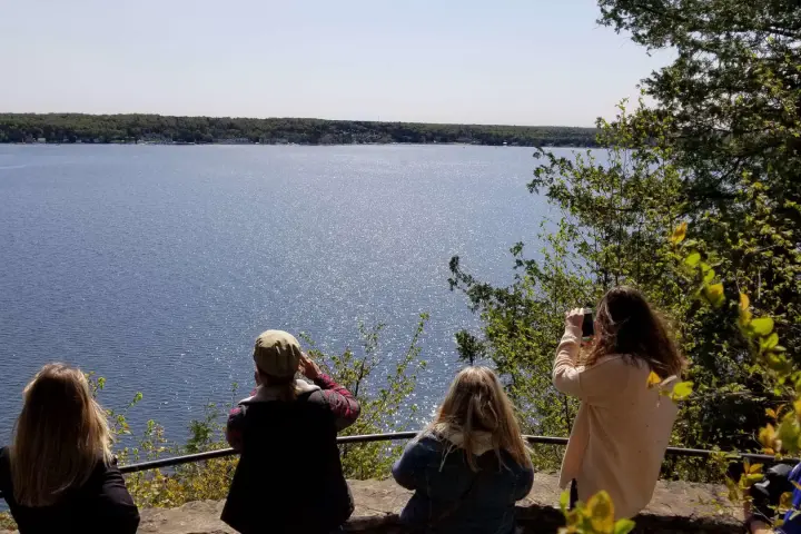 a group of people standing in front of a body of water