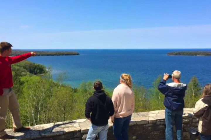 a group of people standing next to a body of water