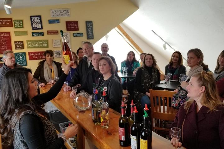 a group of people sitting at a table with wine glasses