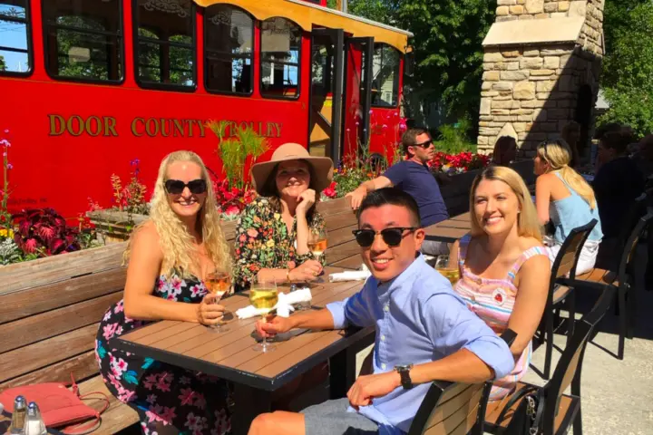 a group of people sitting at a picnic table