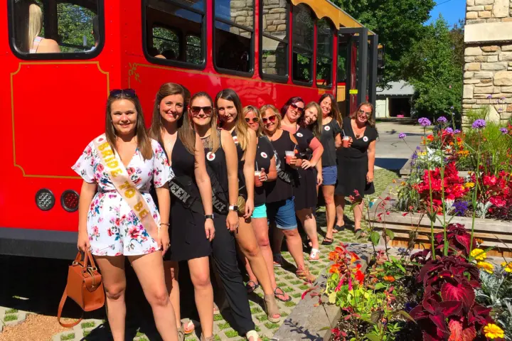 a group of people standing in front of a bus