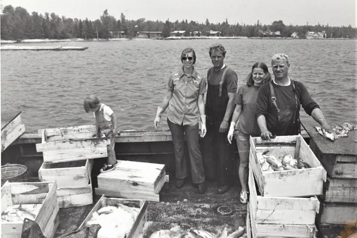 a group of people standing next to a body of water