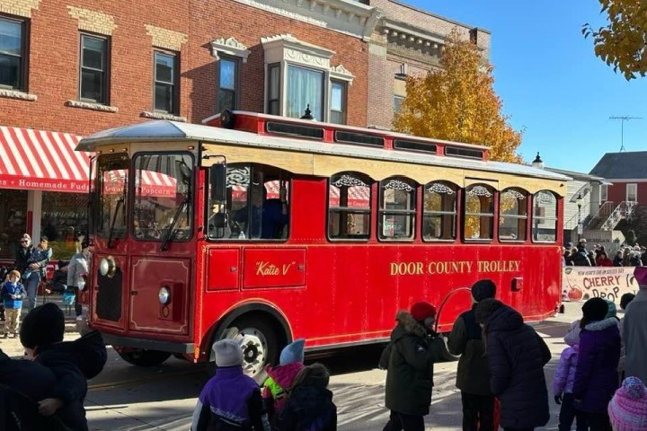 a group of people standing in front of a bus